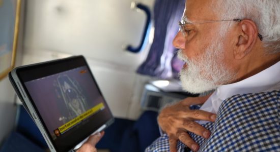Modi seeing Surya Tilak of Ramlala in Ayodhya on tablet